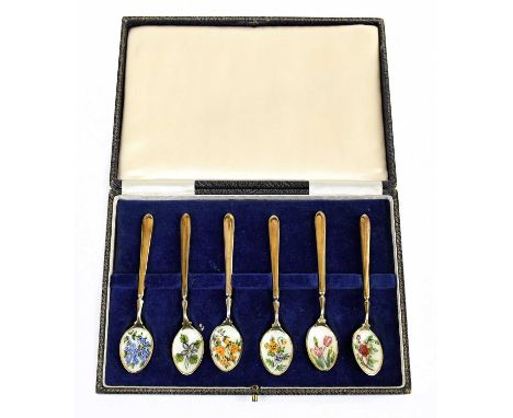 A cased set of six Queen Elizabeth II hallmarked silver gilt and enamel spoons, each bowl decorated with a different flower, 