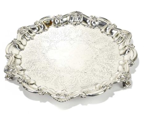 BAKER BROS; a late Victorian hallmarked silver salver, with engraved detailing beneath a shell and scroll border, on scroll f