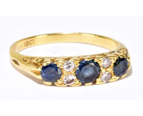 An 18ct yellow gold sapphire and diamond ring, set with three round sapphires and four Swiss cut diamonds, size N, approx. 3.