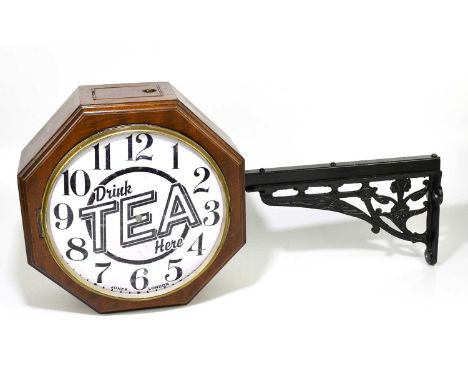 'DRINK TEA HERE'; a vintage enamel and walnut octagonal advertising clock and cast iron bracket, the enamel dial with Arabic 