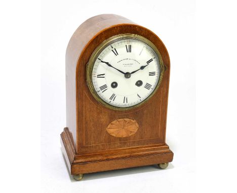 PARKINSON &amp; FRODSHAM; an Edwardian inlaid mahogany cased dome topped mantel clock, on four brass ball feet, height 25cm. 