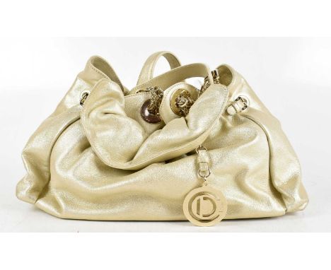 CHRISTIAN DIOR; a metallic gold leather 'Le Trente Hobo' handbag, hand stitched with heavy gold tone 'Dior' bag charm to fron