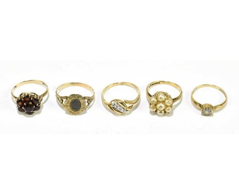 Three 9ct gold dress rings, comprising a garnet set ring, a synthetic pearl ring and a five white stone ring, gross weight 7.