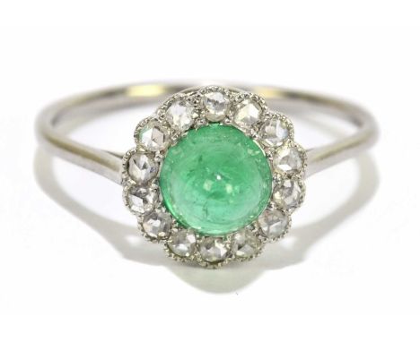 An early 20th century white metal diamond and cabochon emerald floral cluster ring, size M, approx. 2.4g. 