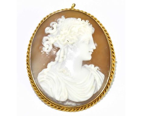 A Victorian 15ct yellow gold framed oval cameo brooch depicting the classical profile portrait bust of a woman, length approx