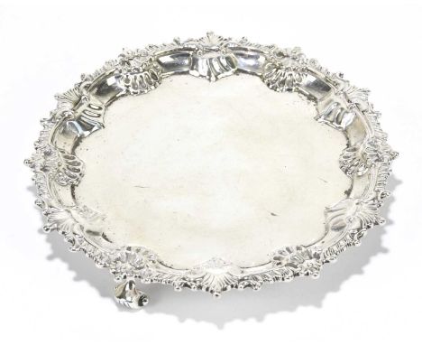 CHARLES STUART HARRIS; a late Victorian hallmarked silver card tray, with gadrooned shell border, on three scroll feet, Londo