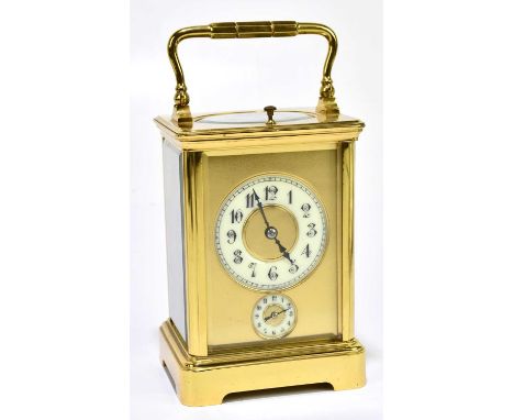 A circa 1900 French brass repeating carriage clock with Arabic numerals to the chapter ring set above subsidiary small dial, 