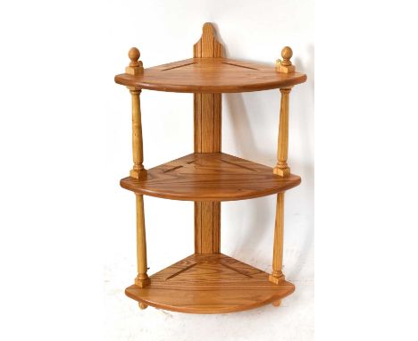 ERCOL; a light elm hanging corner shelf, height 74cm.