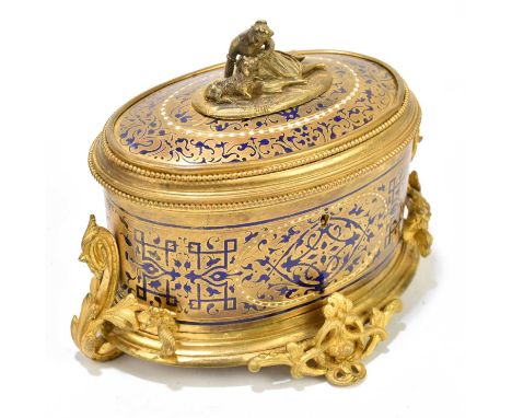 TAHAN; a late 19th century French gilt metal and blue enamel casket of oval form, the cover with oval finial of a maiden feed