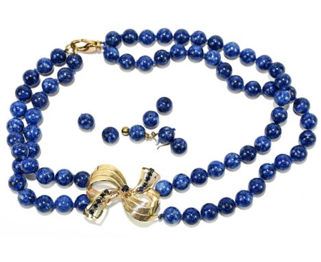 A lapis lazuli bead necklace with 18ct yellow gold bow drop and sprung clasp, length approx. 42cm, and several loose beads.