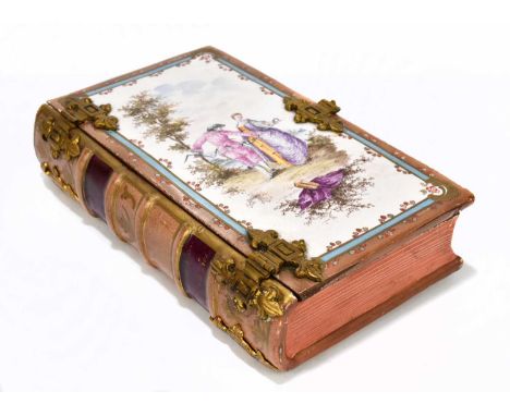 A 19th century French pottery faïence ware trinket box in the form of a book with gilt metal mounts, decorated with a couple 