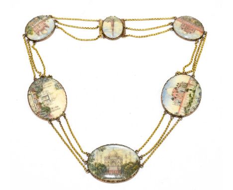 A yellow metal mounted Indian necklace set with six hand painted miniatures on ivory depicting various temples to include the