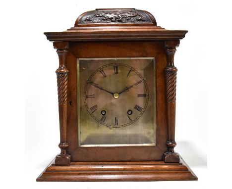A late Victorian walnut eight day mantel clock, the silvered dial with Roman numeral chapter ring and French movement strikin