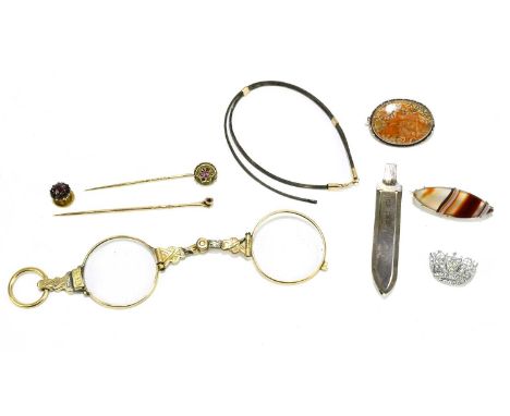 Two polished agate brooches, a pair of gilt metal lorgnettes, a stick pin, and a costume brooch.