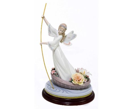 LLADRO; a ceramic figure of an angel on a gondola, with oval stand, height 37cm.Condition Report: Two of the white petals glu