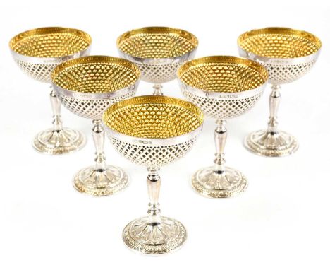 A cased set of six Elizabeth II hallmarked silver champagne bowls with elaborate textured detail, gilt washed interior, turne