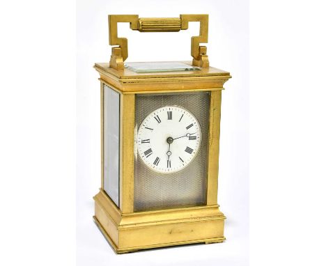 A late 19th century French brass cased carriage clock with swing loop handle above silvered dial set with Roman numerals to t