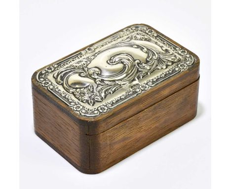 TREVITT &amp; SONS; an Edwardian hallmarked silver mounted oak trinket box with floral scroll detail, Chester 1905, length 12