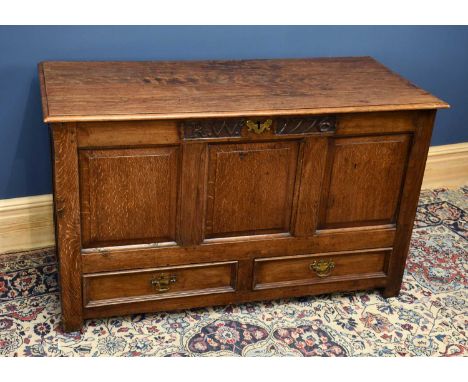 A late 18th century and later oak coffer with carved initials 'R W' and dated 1776 above a panelled front with two base drawe