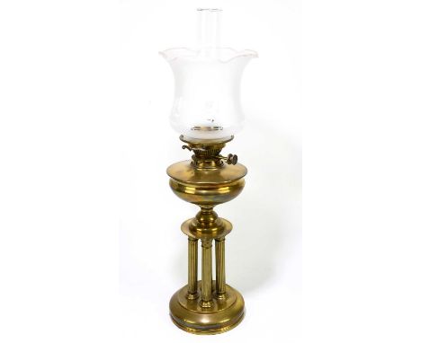 A four column brass oil lamp, with frosted glass shade, height including chimney approx 27cms.