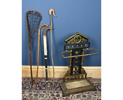 A Victorian cast iron umbrella stand, with portrait roundel to the top, height 84cm.