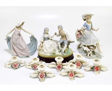 LLADRO; two ceramic figures comprising a maiden with a basket of flowers and a puppy, no.4970, and a further maiden, no.5663,