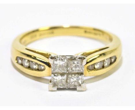 An 18ct yellow gold and diamond set ring, the raised platform set with four princess cut stones with eight small diamonds to 