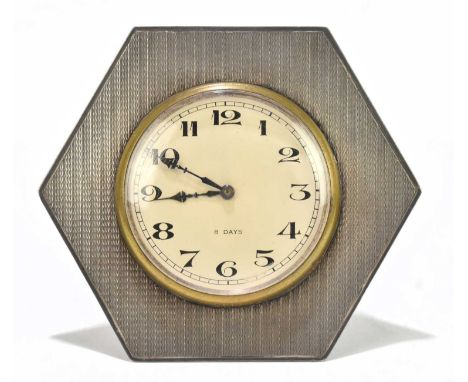 A George V hallmarked silver mounted easel back travelling clock, the circular dial set with Arabic numerals on an eight day 