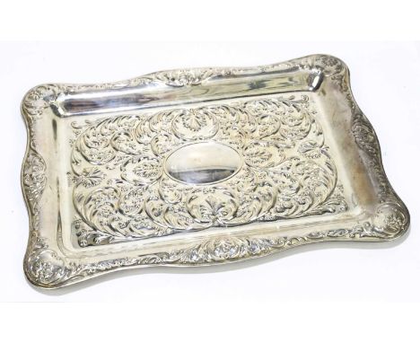A Elizabeth II hallmarked silver dressing table tray with embossed scroll detail and vacant central oval cartouche, Sheffield