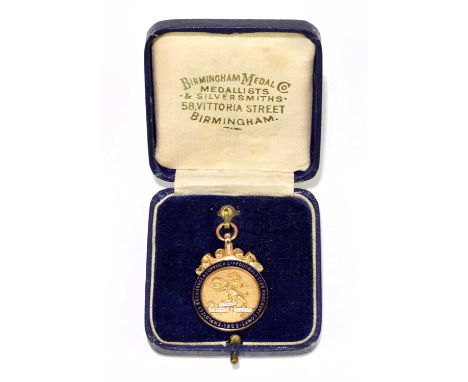 A 9ct yellow gold and enamel fob medal for Backhouse &amp; Coppock Ltd Football Club knock out competition 1922, approx weigh