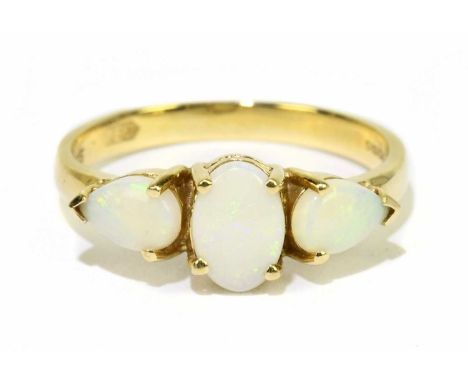 A 14ct yellow gold and opal three stone ring, size M, approx. 2.1g. Condition Report: The opals are not backed, and have very