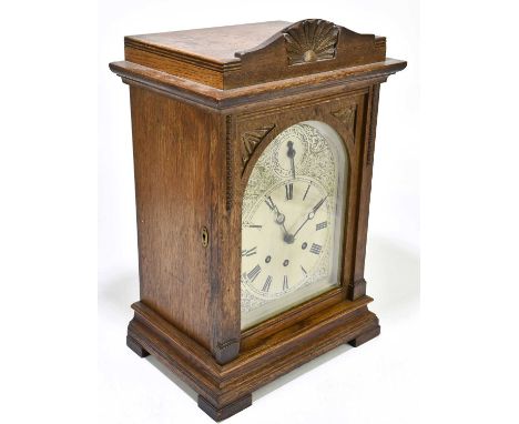 An Edwardian oak cased mantel clock, the silvered dial with Roman numerals and chime / silent subsidiary dial, height 42cm. S