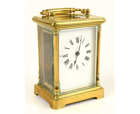 An early 20th century French brass cased carriage clock, the enamel dial set with Roman numerals, height including swing hand