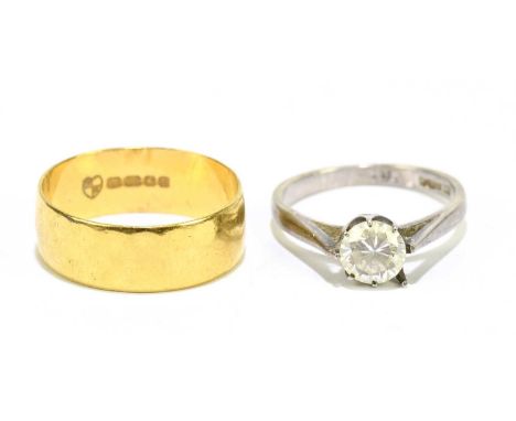 A 22ct yellow gold broad wedding band, size M 1/2, approx. 4.4g, and a silver dress ring (2) 