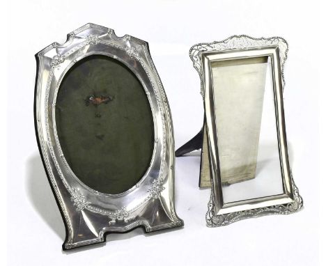 JOSEPH GLOSTER LTD; a George V hallmarked silver photograph frame, with oval aperture and moulded with floral hairbell detail