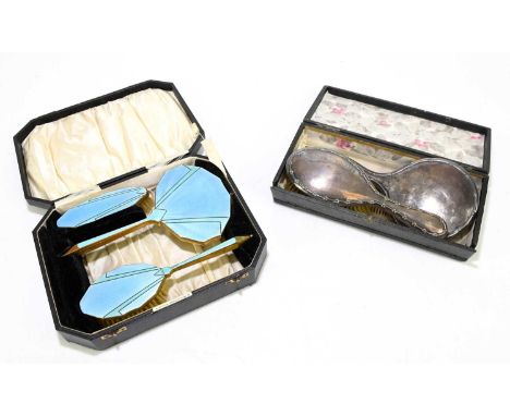 A hallmarked silver three piece dressing table set, Birmingham 1938, with an Art Deco enamel and brass dressing table set (2)