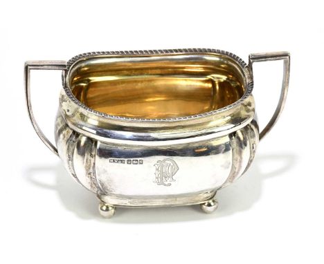 MARK WILLIS &amp; SON; an Edward VII hallmarked silver twin handled sugar bowl, with cast rim and gilded interior, with engra