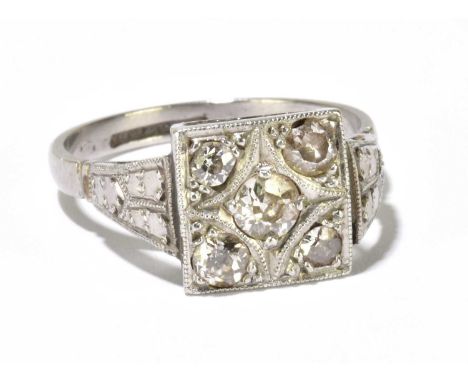 An Art Deco white metal and diamond ring with square platform, set with five old cut diamonds, size M, approximately 3.9g.Con