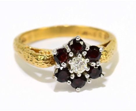 An 18ct yellow gold diamond centred flower head ring, size N, approx. 5.3g.