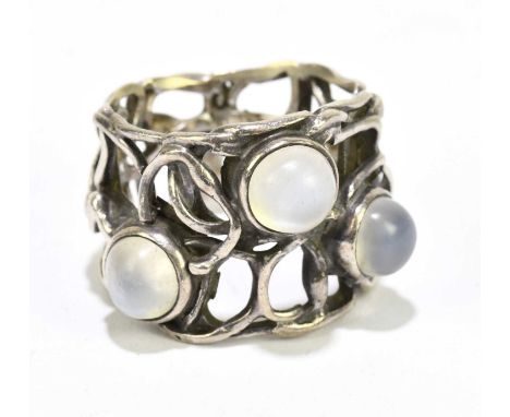 IN THE STYLE OF MURRLE BENNETT; a white metal and moonstone broad pierced ring, size M, approx. 9.4g, unmarked.