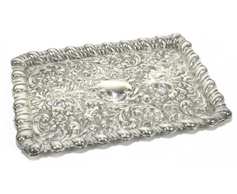 ROBERT PRINGLE; an Edwardian hallmarked and embossed silver dressing table tray decorated with two green man masks and overal
