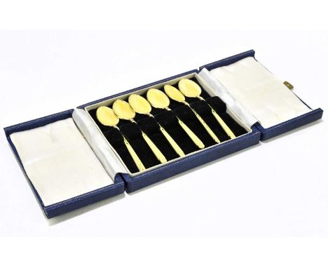 A cased set of six Elizabeth II hallmarked silver and yellow enamel coffee spoons, Birmingham 1960.Condition Report: Three sp