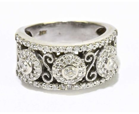 A 14ct white gold and diamond set broad pierced ring, size K 1/2, approx. 7.25g.