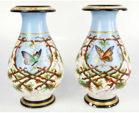 A pair of late 19th century porcelain vases, possibly Paris, hand painted with butterflies inside woodland border, height 29c
