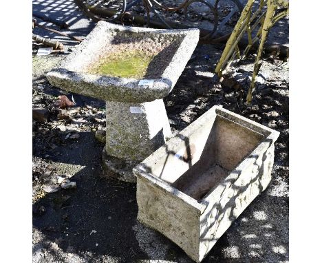 A three section stone bird bath, height 40cms, together with a composite trough, height 23cms.