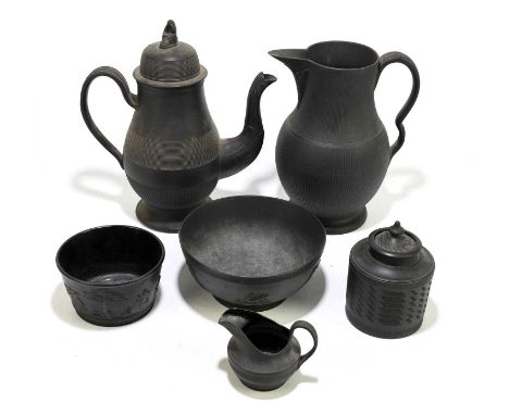 A late 18th/early 19th century black basalt jug, coffee pot and cover, and tea caddy and cover, unmarked, possibly Wedgwood, 