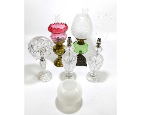 Three cut glass table lamps, one with a domed shade, tallest 39cm, with a Victorian oil lamp with green glass reservoir, conv
