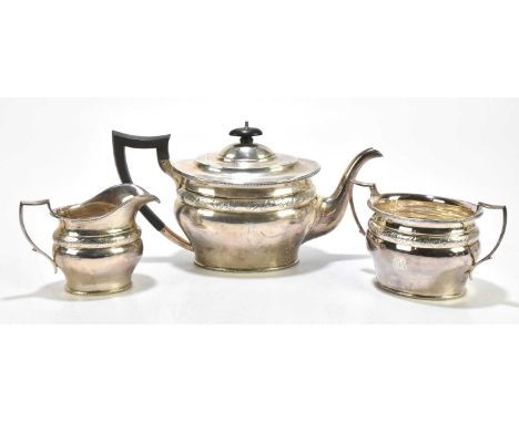 GOLDSMITHS &amp; SILVERSMITHS COMPANY LTD; a George V hallmarked silver three piece tea service of oval form, with cast detai