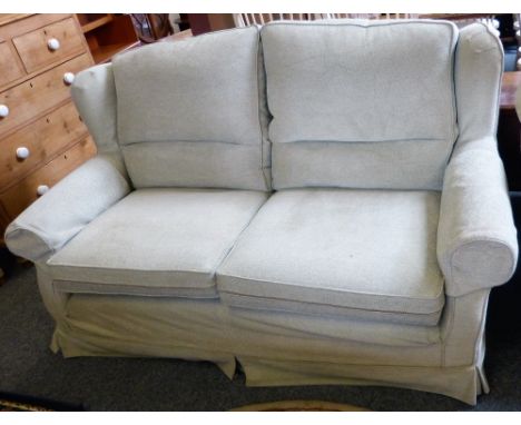 A Multiyork light green patterned four-cushion two-seater settee.