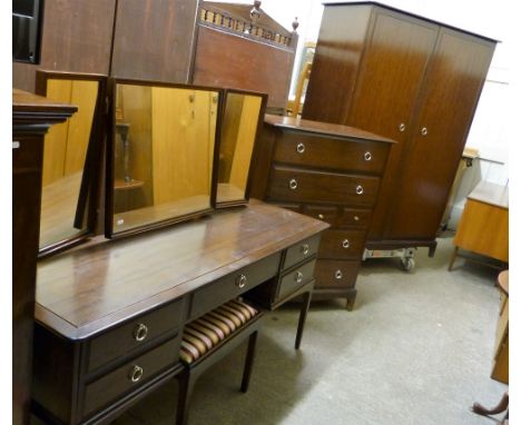 A Stag Minstrel mahogany four-piece bedroom suite comprising wardrobe, multi drawer chest and dressing table with stool.